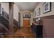 Hallway featuring wood floors, wainscoting, stone accent and a dart board for added entertainment at 24 Shannon Rd, Zionsville, IN 46077
