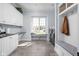Well-lit laundry room with white cabinetry, washer and dryer, and window seat at 24 Shannon Rd, Zionsville, IN 46077
