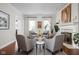 Bright living room features four chairs surrounding a round table and a fireplace with decorative mantle at 24 Shannon Rd, Zionsville, IN 46077