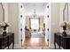 View into cozy living room through double doors with chandelier and decorative rug at 24 Shannon Rd, Zionsville, IN 46077