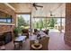 Covered patio with fireplace, outdoor seating, and views of the pool and landscaped yard at 24 Shannon Rd, Zionsville, IN 46077