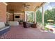 Expansive brick patio with multiple seating areas and an outdoor fireplace providing ample space for relaxation and gatherings at 24 Shannon Rd, Zionsville, IN 46077