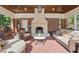 Outdoor patio with stone fireplace and brick surround, featuring comfortable seating and a wood planked ceiling at 24 Shannon Rd, Zionsville, IN 46077