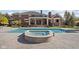 Stunning backyard oasis with a pool, hot tub, and covered patio with white columns at 24 Shannon Rd, Zionsville, IN 46077