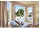 Comfortable chaise lounge with a view of the pool and pool house through a bay window at 24 Shannon Rd, Zionsville, IN 46077