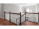 Elegant staircase with a chandelier, white railings and wooden handrail at 24 Shannon Rd, Zionsville, IN 46077