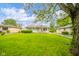 Charming single-story home with a well-manicured lawn and mature tree at 2726 Apache Dr, Anderson, IN 46012