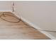 Neutral colored flooring with matching base trim on a blank wall with outlets at 2726 Apache Dr, Anderson, IN 46012