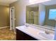 Bathroom featuring double sink vanity with a large mirror, with a view of a tub and shower stall at 276 Rocky Rd, Greenfield, IN 46140