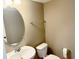 Bathroom featuring a white sink, oval mirror, toilet and chrome hardware at 276 Rocky Rd, Greenfield, IN 46140