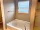Bright bathroom showcases a modern bathtub with chrome fixtures next to a glass enclosed shower at 276 Rocky Rd, Greenfield, IN 46140