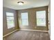 Sun-filled bedroom with plush carpeting, three windows providing great natural light, and neutral paint at 276 Rocky Rd, Greenfield, IN 46140