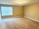 Bedroom with neutral carpet, light tan walls, and a window for natural light at 276 Rocky Rd, Greenfield, IN 46140