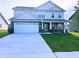 Beautiful two-story home with a brick-accented facade, well-manicured lawn and a large two car garage at 276 Rocky Rd, Greenfield, IN 46140