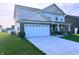 Lovely two-story house featuring a two-car garage, a well-kept lawn and a brick-accented facade at 276 Rocky Rd, Greenfield, IN 46140