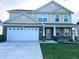 Charming two-story home featuring a brick-accented facade, a two-car garage and a well-kept lawn at 276 Rocky Rd, Greenfield, IN 46140
