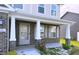 Inviting front porch featuring stylish columns, brick accents, shuttered windows and a decorative front door at 276 Rocky Rd, Greenfield, IN 46140