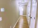 Hallway with wood floor leading to the front door and featuring multiple closets at 276 Rocky Rd, Greenfield, IN 46140