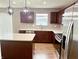 Modern kitchen featuring a center island, stainless steel appliances, dark cabinets and modern pendant lighting at 276 Rocky Rd, Greenfield, IN 46140