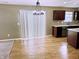 Kitchen area featuring wood floors, modern cabinets, countertops, and vertical window blinds at 276 Rocky Rd, Greenfield, IN 46140