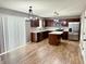 Modern kitchen with stainless steel appliances, wood cabinets, island, and wood flooring at 276 Rocky Rd, Greenfield, IN 46140