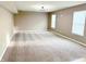 Spacious living room with carpet, light tan walls, a modern chandelier and large windows at 276 Rocky Rd, Greenfield, IN 46140