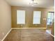 Living room featuring neutral carpet, light walls, a modern chandelier and a view into the front entry at 276 Rocky Rd, Greenfield, IN 46140