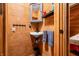 Bathroom featuring a vanity sink, medicine cabinet, and natural wood paneling at 2781 E Vandalia Rd, Flat Rock, IN 47234