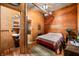 Bedroom featuring a queen bed, with hardwood floors, and an adjacent bathroom at 2781 E Vandalia Rd, Flat Rock, IN 47234