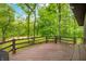 The home's deck overlooking a lush forest and river in the background at 2781 E Vandalia Rd, Flat Rock, IN 47234