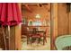 Inviting dining room features wood-paneled walls, a table for four, and easy access to the kitchen area at 2781 E Vandalia Rd, Flat Rock, IN 47234