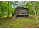 Charming home exterior with a red door, quaint porch, and nestled among mature trees at 2781 E Vandalia Rd, Flat Rock, IN 47234