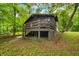 Charming two-story home with a deck surrounded by lush greenery at 2781 E Vandalia Rd, Flat Rock, IN 47234