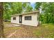 Back of home featuring a simple exterior, surrounded by trees and natural landscaping at 2781 E Vandalia Rd, Flat Rock, IN 47234