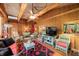 Comfortable living room featuring wood paneling, cathedral ceiling, and cozy seating arrangement at 2781 E Vandalia Rd, Flat Rock, IN 47234