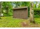 Well-maintained wooden outbuilding nestled among trees, offering practical outdoor storage space at 2781 E Vandalia Rd, Flat Rock, IN 47234