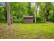 Charming wooden outbuilding in a wooded area, providing functional outdoor storage at 2781 E Vandalia Rd, Flat Rock, IN 47234