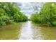 Serene river view surrounded by lush greenery under a partly cloudy sky at 2781 E Vandalia Rd, Flat Rock, IN 47234