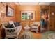 Inviting sitting area with wicker furniture, wood walls, and a bright window at 2781 E Vandalia Rd, Flat Rock, IN 47234