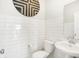 This bathroom has a bright white subway-tiled wall and modern fixtures, creating a clean and appealing space at 2922 Woods Edge Dr, Greenwood, IN 46143