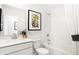 Clean and modern bathroom with black and gold accents, white cabinets, and stylish art at 2922 Woods Edge Dr, Greenwood, IN 46143