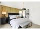 This bright bedroom features an accent wall, dark furniture, a bench, and natural light from a window at 2922 Woods Edge Dr, Greenwood, IN 46143