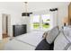 Bright bedroom featuring a water view from the windows, complete with neutral bedding and a pendant lamp at 2922 Woods Edge Dr, Greenwood, IN 46143