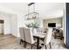 Elegant dining area with modern light fixture, neutral decor, and open view to the living space at 2922 Woods Edge Dr, Greenwood, IN 46143