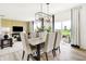 Bright dining room with stylish lighting, neutral decor, and an open concept floor plan at 2922 Woods Edge Dr, Greenwood, IN 46143