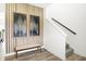 Inviting foyer featuring modern decor, artwork, a bench, wood-look floors, and staircase at 2922 Woods Edge Dr, Greenwood, IN 46143
