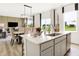 Bright kitchen island features stainless steel appliances, quartz countertops, and view to the backyard at 2922 Woods Edge Dr, Greenwood, IN 46143