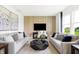 This is a bright living room with neutral furniture and decor including sofas and a dark-colored coffee table at 2922 Woods Edge Dr, Greenwood, IN 46143