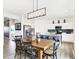 Dining area with kitchen island in the background with stainless steel appliances and bar seating at 2948 Woods Edge Dr, Greenwood, IN 46143
