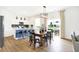 Dining area with wood table and island with barstool seating and view to the backyard at 2948 Woods Edge Dr, Greenwood, IN 46143